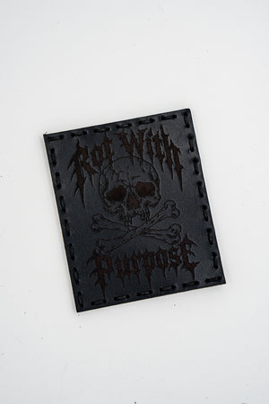 Rot with Purpose leather morale patch: skull and crossbones with Rot With Purpose in metal-style lettering, black leather, hand sewn with black thread and hook backing
