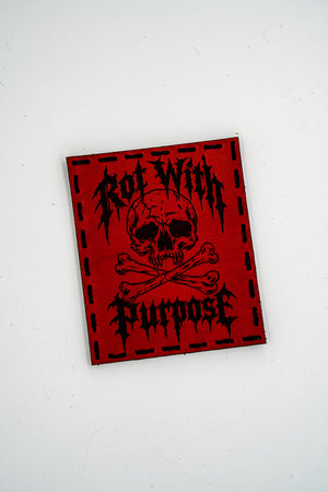 Rot with Purpose leather morale patch: skull and crossbones with Rot With Purpose in metal-style lettering, red leather, hand sewn with black thread and hook backing
