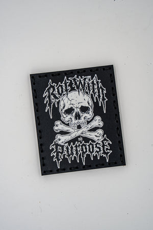 Rot with Purpose leather morale patch: skull and crossbones with Rot With Purpose in metal-style lettering, black veg-tanned leather with white UV print, hand sewn with hook backing
